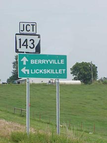this photo is of the highway 143 junction sign with an arrow pointing left to Lickskillet